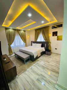 a bedroom with a large bed and a large window at Officer Condo Apartments in Yanyan