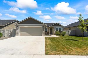 a house with a garage in a yard at Caldwell Ruby Tuesday! 60's Inspired comfort 3B2B in Caldwell