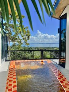 a swimming pool with a view of the ocean from a house at deep mountain view in Ko Larn