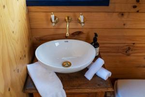 a bathroom with a sink and a bottle of champagne at Tiny Truck at Ithaca - Mudgee's Most Unique Stay in Mudgee