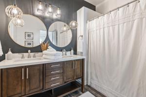 a bathroom with two sinks and two mirrors at The Bella! West Nampa Private 3 Bedroom Home in Nampa +22 photos