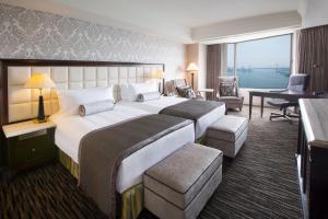 a hotel room with a large bed and a desk at InterContinental Tokyo Bay by IHG in Tokyo