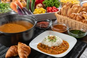 a table with a plate of food and a bowl of soup at Far East Village Hotel Tokyo Ariake in Tokyo