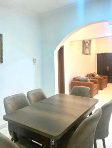 a dining room with a table and chairs at Bays Lodge - East Legon in Accra