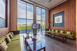 a living room with a couch and a tv at Amber Cove Premier Suites Melaka in Melaka