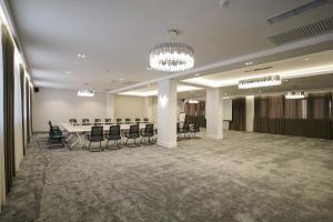 a conference room with a long table and chairs at Milan Hotel in Tashkent +69 photos