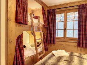 a bedroom with a bunk bed and a window at Residence Bastide in Verbier