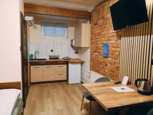 a small kitchen with a table and a counter top at Pokoje Jola in Drawsko Pomorskie
