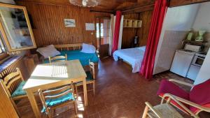 a room with a bed and a table and chairs at Chalet l'Acinos in Montgenèvre