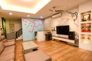uma sala de estar com um sofá e uma televisão em 澎湖金宿喜民宿Penghu Comfy B&B em Magong