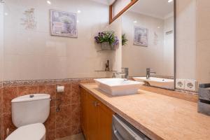 a bathroom with a toilet and a sink and a tub at Apartamento playa 5 primera linea in Fuengirola +12 photos