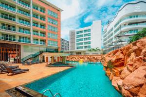 a swimming pool in the middle of a building at Centara Nova Hotel Pattaya in Pattaya