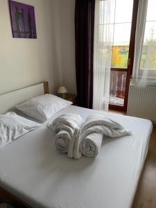 a bedroom with two beds with white towels on them at Apártmany Velká Lomnica B4-AD1 in Veľká Lomnica