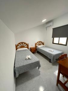 Cama o camas de una habitación en Hostal La Campiña