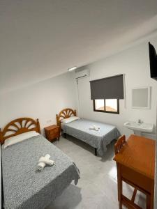 Cama o camas de una habitación en Hostal La Campiña