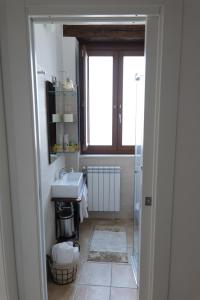 a bathroom with a sink and a window at La Dimora di Euterpe in Ruviano