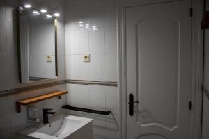 a bathroom with a sink and a shower with a mirror at Ático con terraza en Cuesta Gomérez in Granada +21 photos