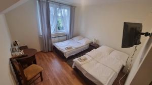 מיטה או מיטות בחדר ב-Hotel MONIKA