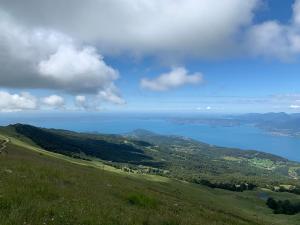 a view of the ocean from the top of a hill at Rifugio Chierego - 1911m in Brenzone sul Garda