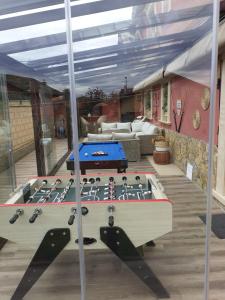 a pool table on the deck of a house at Alojamientos Marte casa rural in Suances