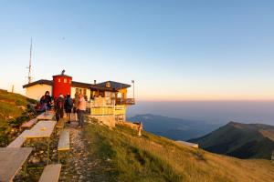 a group of people standing on top of a mountain at Rifugio Chierego - 1911m in Brenzone sul Garda