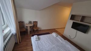 a small room with a bed and a television at Hotel MONIKA in Maków Mazowiecki