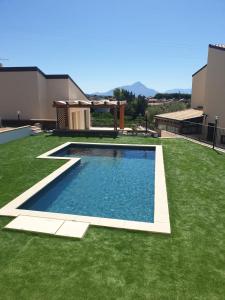 - une piscine dans une cour avec de l'herbe verte dans l'établissement Villa Laura, à Cefalù