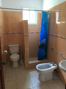 a bathroom with a toilet and a shower and a sink at Sunny Apartment in Bayahibe