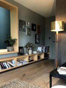 a living room with a book shelf with books at 3 Bedroom Penthouse Apartment in Manchester