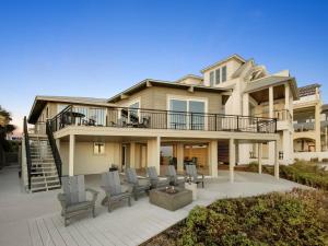 a large house with a deck and patio at Nifty Shades Of Gray Home in Inlet Beach