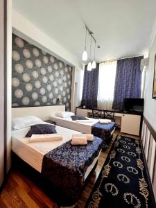 a bedroom with two beds and a tv in it at IRIS Hotel in Chişinău