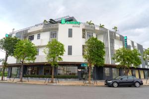 a car parked in front of a building at Bambu Hotel in Da Nang