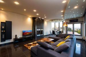 a large living room with a couch and a tv at Casa Grande Private Luxury Villa in Alykes Potamou