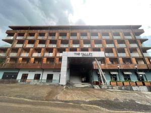 a large brick building with the walkway in front of it at The Charmer @ The Valley in Bakuriani
