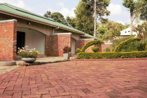 a brick driveway in front of a house at PaTerrace guest lodge in Harare