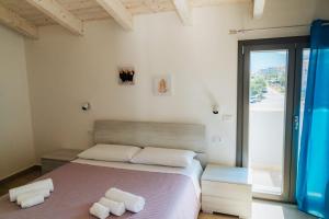 Posteľ alebo postele v izbe v ubytovaní Casa Vacanze Oltre La Caletta - 350 mt dalla spiaggia
