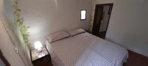 a small bedroom with a bed in a room at Characteristic house Aquasanta in Lecchiore