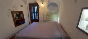 a bedroom with a bed in a room with a window at Characteristic house Aquasanta in Lecchiore