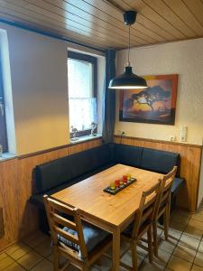 een eetkamer met een houten tafel en stoelen bij Ferienwohnung Schanz in Konken