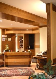 a large lobby with a salon with a wooden salonasteryasteryasteryasteryasteryastery at Hotel Wanda in Pinzolo