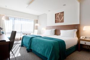 Uma cama ou camas num quarto em EPIC SANA Lisboa Hotel