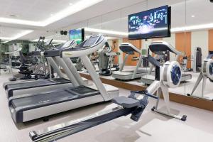 a gym with cardio machines and a flat screen tv at EPIC SANA Lisboa Hotel in Lisbon