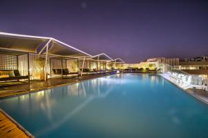 a view of a swimming pool at night at EPIC SANA Lisboa Hotel in Lisbon +24 photos
