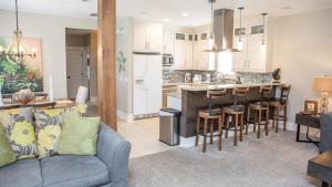 a living room with a couch and a kitchen at Dolphin House in Santa Rosa Beach