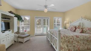 a bedroom with a bed and a tv and windows at Float Away in Panama City Beach +61 photos