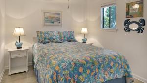 a bedroom with a bed and two night stands with lamps at Hidden Beach 117 in Santa Rosa Beach +38 photos