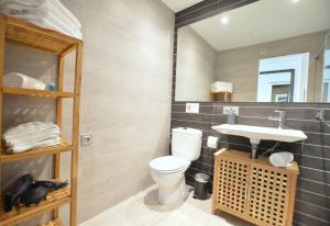 a bathroom with a toilet and a sink at House 200m from Puerto de Sóller Beach in Port de Soller +14 photos