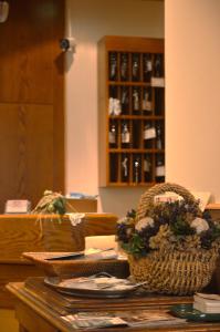 a room with a table with a chair and a cabinet at Hotel Wanda in Pinzolo