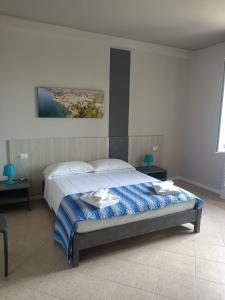 a bedroom with a bed and a painting on the wall at Villa Molino in Moniga +52 photos