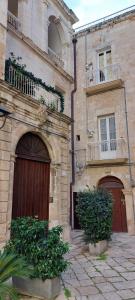 an old building with two entrances and two gates at Dimora a Palazzo in Monopoli